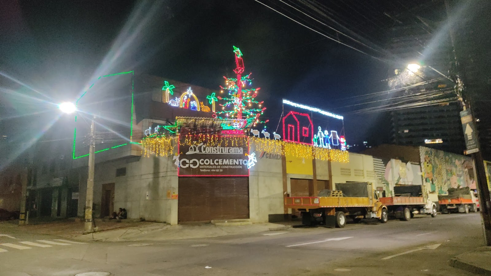 Fachada de Colcemento iluminada de noche en Medellín
